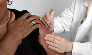 Doctor administers vaccine to patient